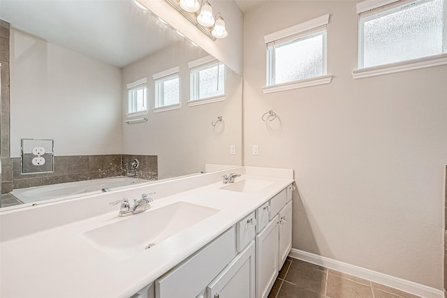 bathroom with tile patterned flooring, vanity, and a bathtub