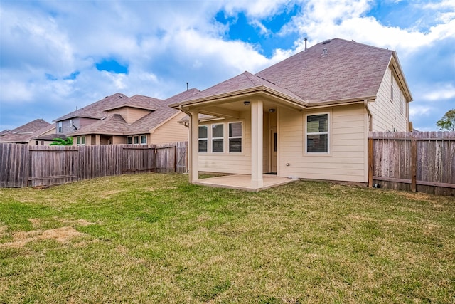 back of property featuring a yard and a patio