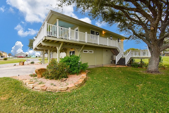 back of property with a deck and a lawn