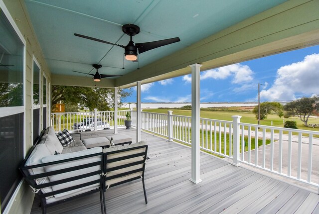 wooden terrace featuring a porch, an outdoor living space, and ceiling fan