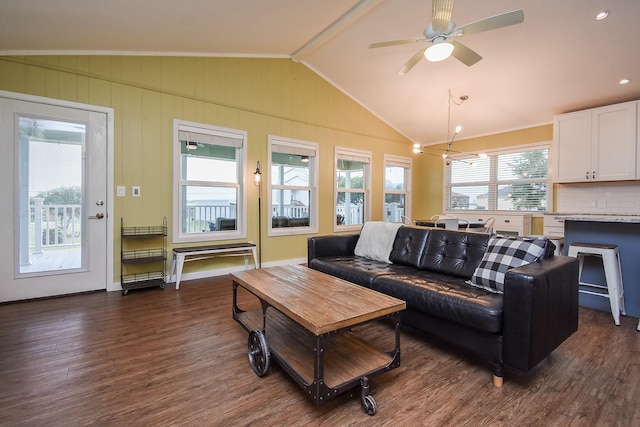 living room featuring ceiling fan with notable chandelier, dark hardwood / wood-style floors, and lofted ceiling