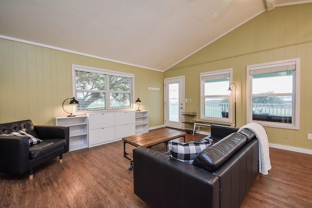 living room featuring wood walls, hardwood / wood-style floors, vaulted ceiling, and ornamental molding