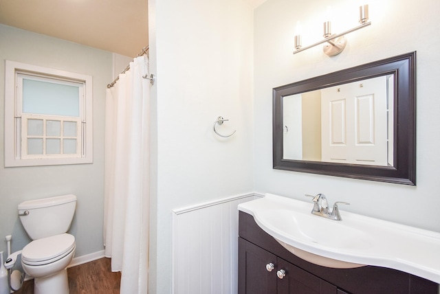 bathroom featuring vanity, hardwood / wood-style flooring, and toilet