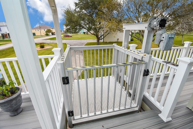 wooden deck featuring a lawn