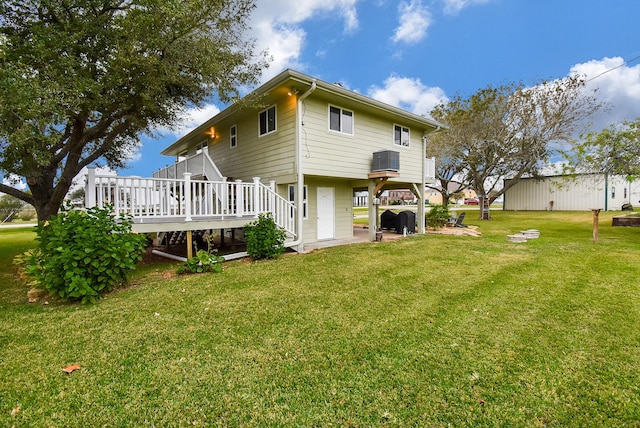 rear view of house with a deck and a lawn