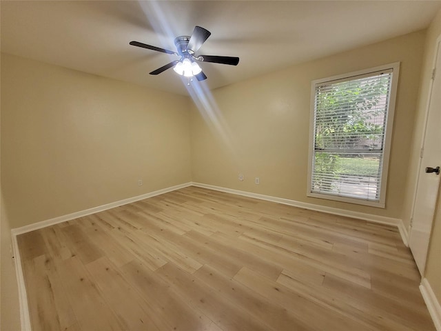 empty room with light wood-type flooring, baseboards, and a ceiling fan