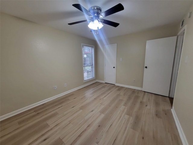 unfurnished bedroom with light wood-style flooring, baseboards, and ceiling fan