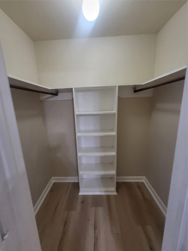 spacious closet with wood finished floors