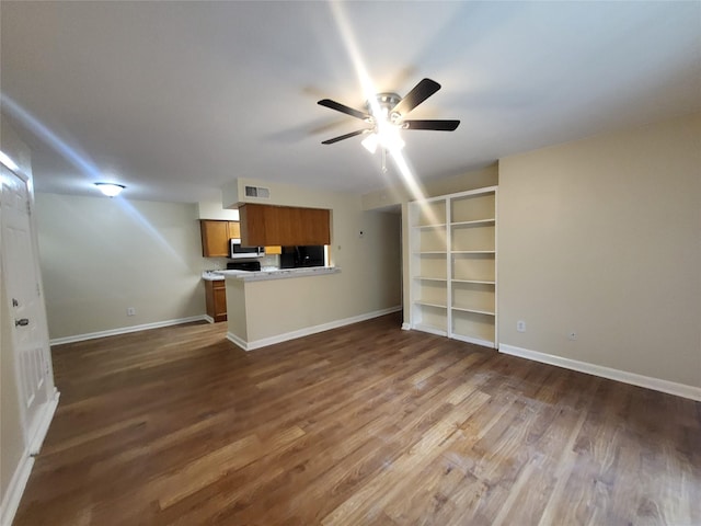 unfurnished living room with ceiling fan, dark wood-type flooring, visible vents, and baseboards