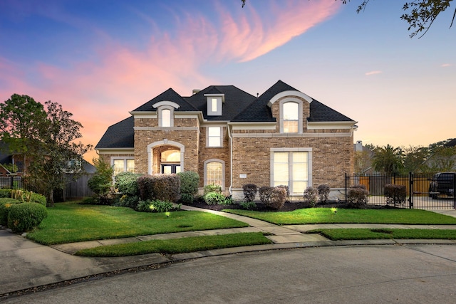 french country home featuring a yard