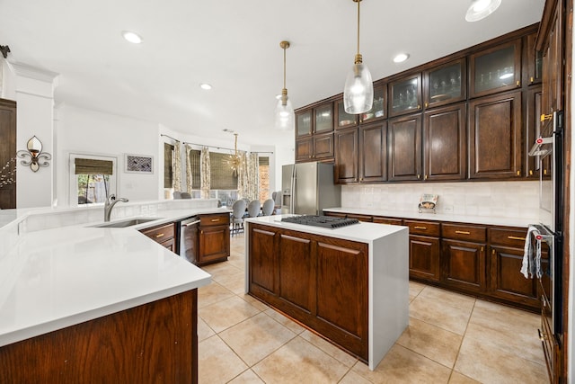 kitchen with a center island, sink, dark brown cabinetry, and stainless steel appliances