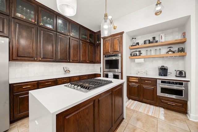 kitchen with dark brown cabinets, light tile patterned floors, appliances with stainless steel finishes, and tasteful backsplash