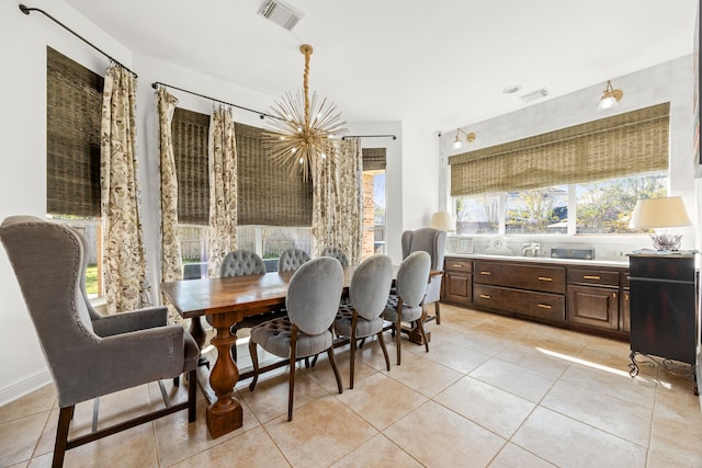 tiled dining area featuring a notable chandelier