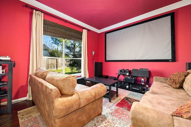 home theater room with ornamental molding and hardwood / wood-style flooring