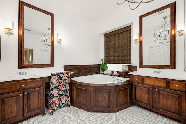 bathroom with tile patterned flooring, vanity, and a bathing tub