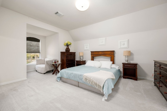 bedroom featuring light carpet and lofted ceiling