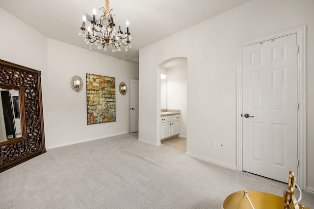 interior space with light colored carpet and a chandelier