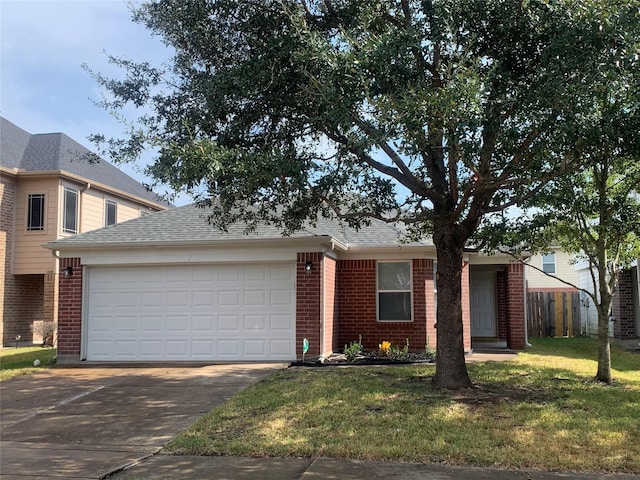 view of front of property featuring a front yard and a garage