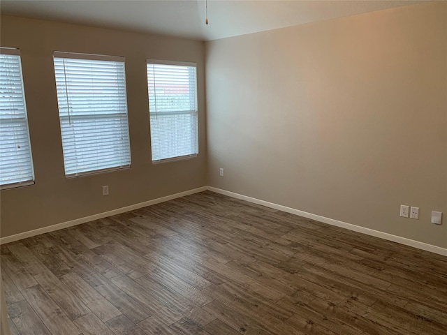 spare room with dark hardwood / wood-style floors