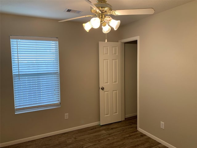 spare room featuring dark hardwood / wood-style floors and ceiling fan