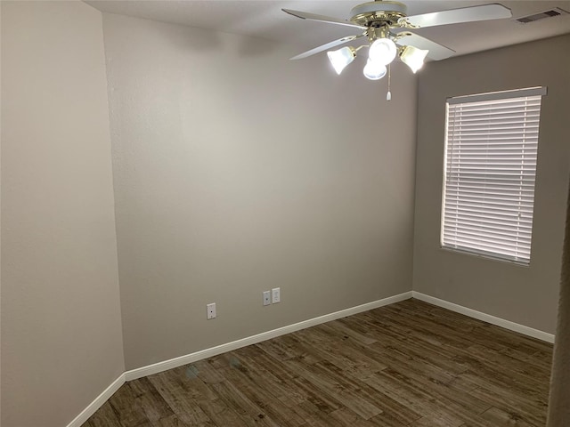 spare room featuring ceiling fan and dark wood-type flooring