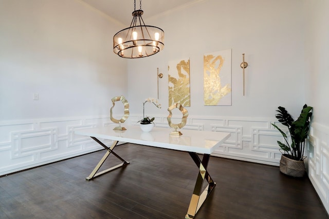 dining area with ornamental molding, dark wood-type flooring, and an inviting chandelier