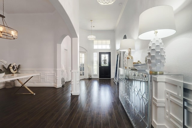 foyer with dark hardwood / wood-style floors and ornamental molding