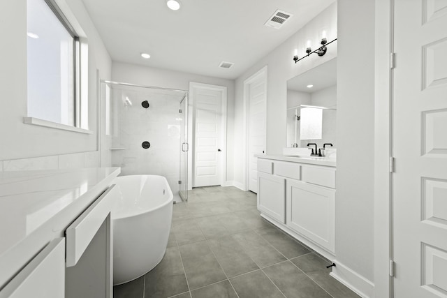 bathroom featuring tile patterned floors, vanity, and shower with separate bathtub