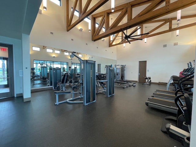 workout area featuring high vaulted ceiling and ceiling fan