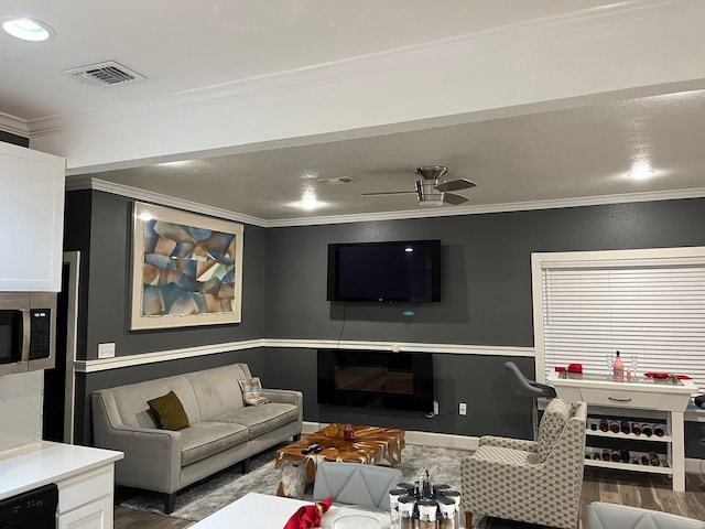 living room with ceiling fan, dark hardwood / wood-style floors, and ornamental molding