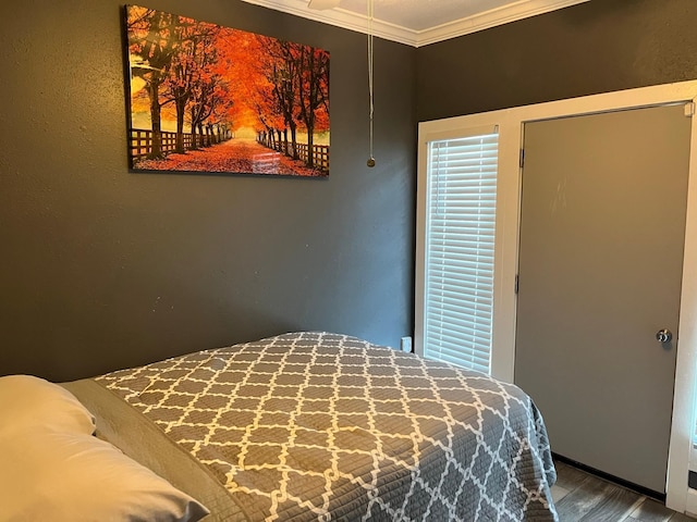 bedroom featuring hardwood / wood-style flooring and crown molding