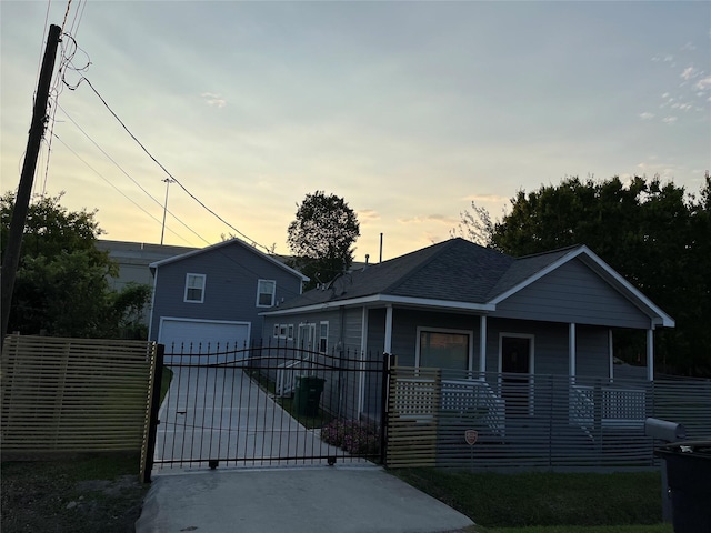 bungalow featuring a porch and a garage