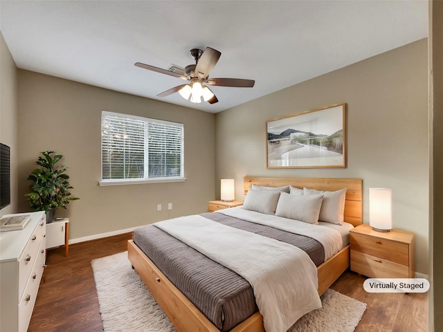 bedroom with ceiling fan and dark hardwood / wood-style floors