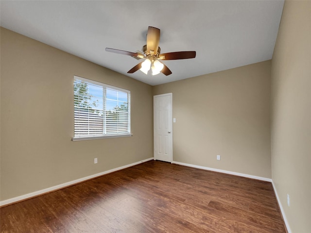 empty room with ceiling fan and dark wood-type flooring