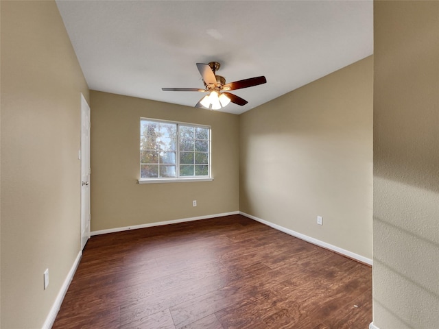 empty room with dark hardwood / wood-style floors and ceiling fan