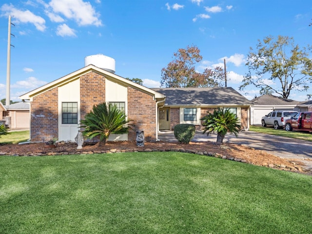 ranch-style home featuring a garage and a front yard