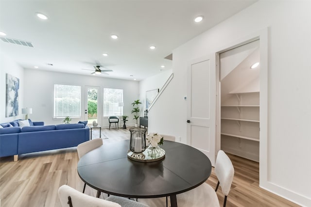 dining space with ceiling fan and light hardwood / wood-style flooring