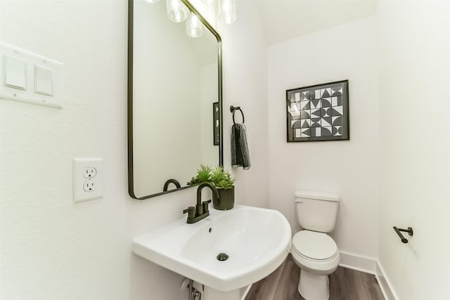 bathroom with sink, toilet, and hardwood / wood-style flooring