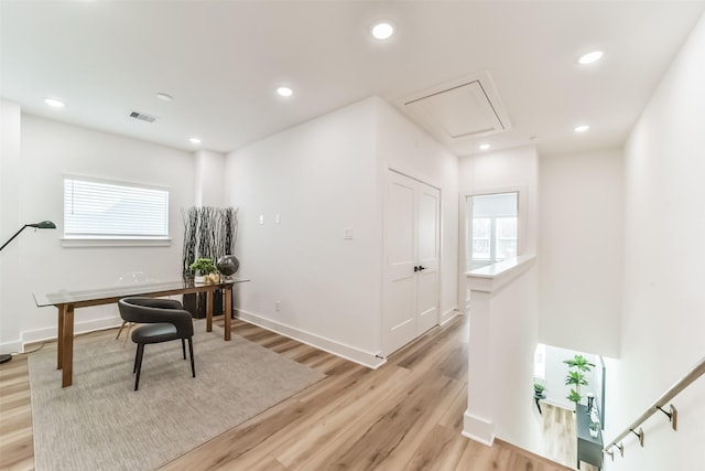 home office with light hardwood / wood-style floors