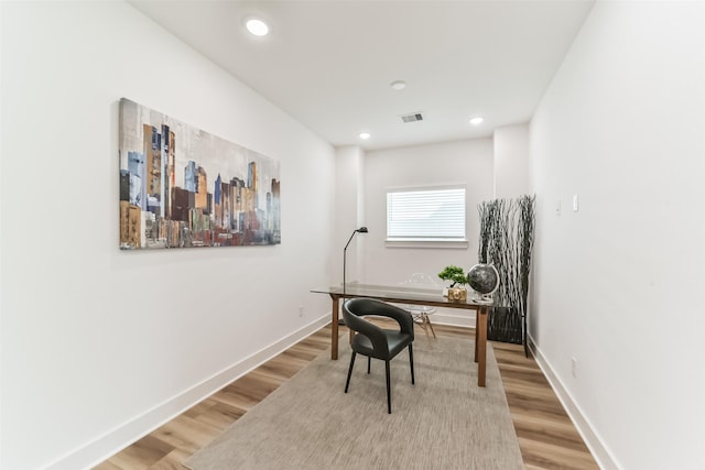 home office with hardwood / wood-style flooring