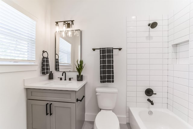 full bathroom featuring toilet, vanity, and tiled shower / bath