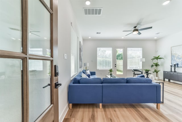 living room with ceiling fan and wood-type flooring