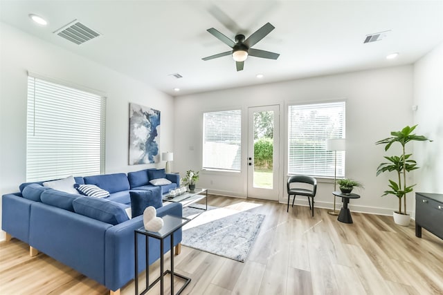 living room featuring light wood-type flooring and ceiling fan