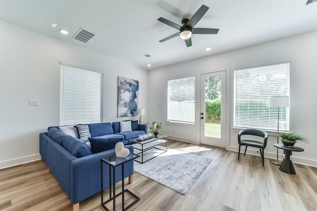 living room featuring ceiling fan and light wood-type flooring