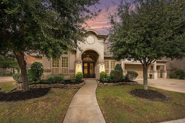 mediterranean / spanish house featuring french doors and a garage