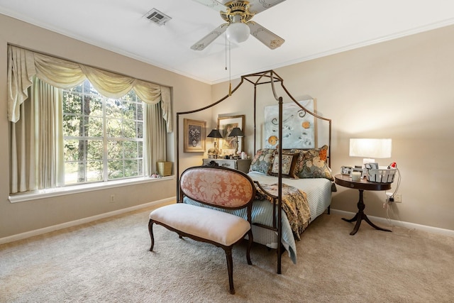 carpeted bedroom featuring crown molding and ceiling fan