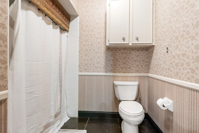 bathroom with tile patterned floors and toilet