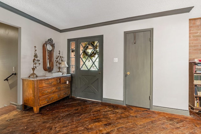 entrance foyer featuring crown molding, dark wood-type flooring, and a textured ceiling