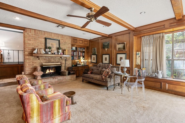 carpeted living room with a fireplace, beam ceiling, wooden walls, and a textured ceiling