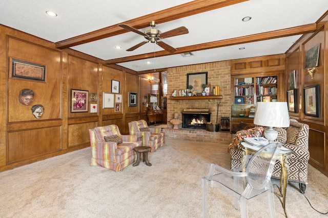 living room with built in features, a fireplace, light carpet, beamed ceiling, and wood walls